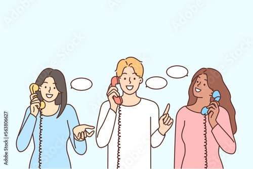 Smiling diverse people talk on landline phones 