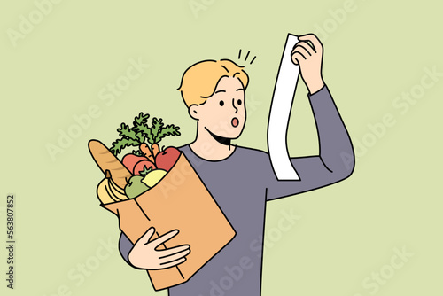 Stunned young man with bag or groceries shocked by expenses in supermarket. Amazed guy surprised with prices on food and products in shop. Vector illustration. 
