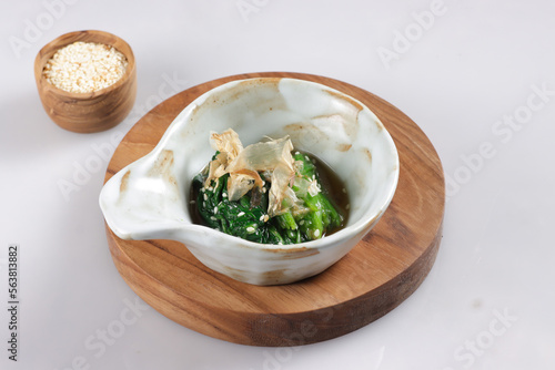 Spinach Ohitashi is a Dish in wich Spinach Stepped in a Dashi Based Sauce, served with bonito flakes.  photo