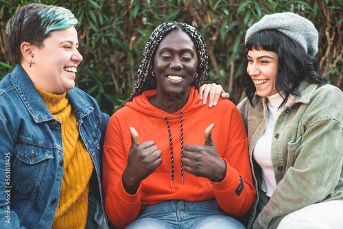 Quadro em tela Three Female Friends Laughing and Having Fun Together chatting sitting at the pa