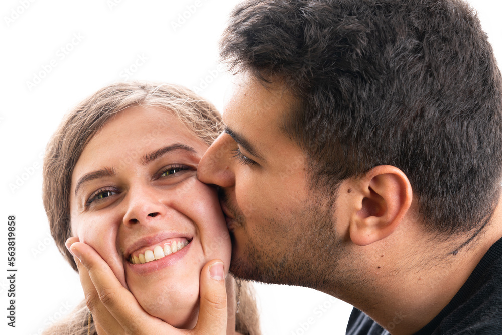 Fototapeta premium Boyfriend kissing cute girlfriend cheek as couple concept