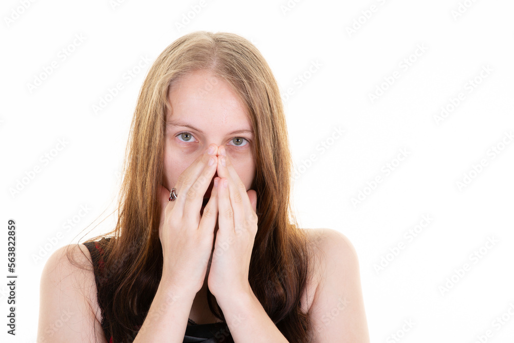 Young blonde woman hide face in palm hands blink through finger frightened afraid nervous Young blonde woman hide face in palm hands blink through finger frightened afraid nervous