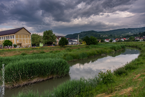 Romania, Bistrita, Houses and blocks nearb the Bistrita River in June 2022
