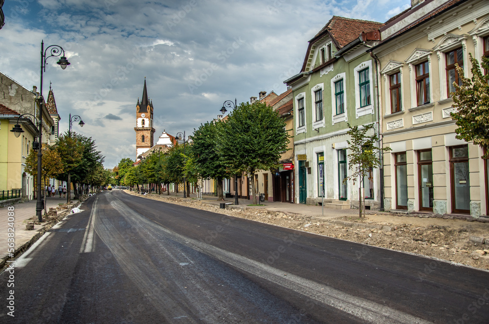 Gheorghe Sincai Street newly paved in Bistrita, Romania, August 2022 and Evabghelica Church in the background