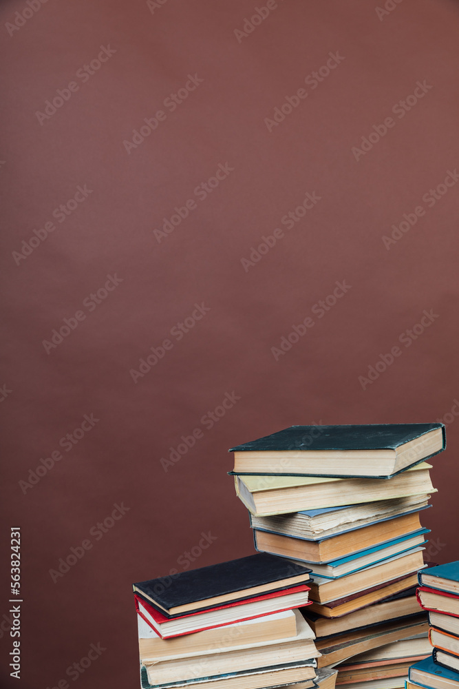 a stack of old instructional books on a brown background a stack of old instructional books on a brown background