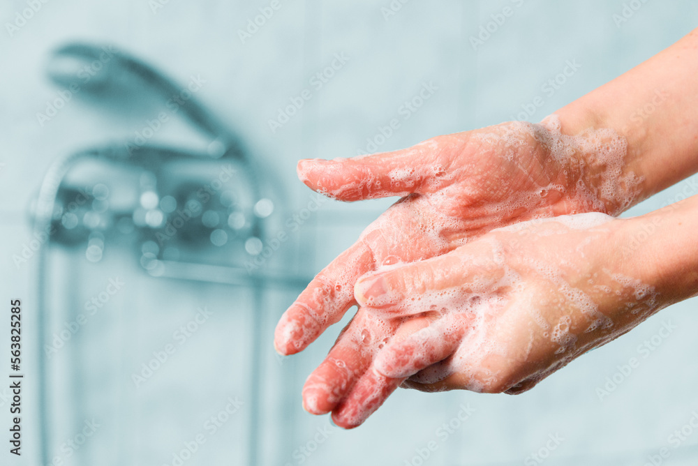 Woman washes her hands with foam soap Woman washes her hands with foam soap