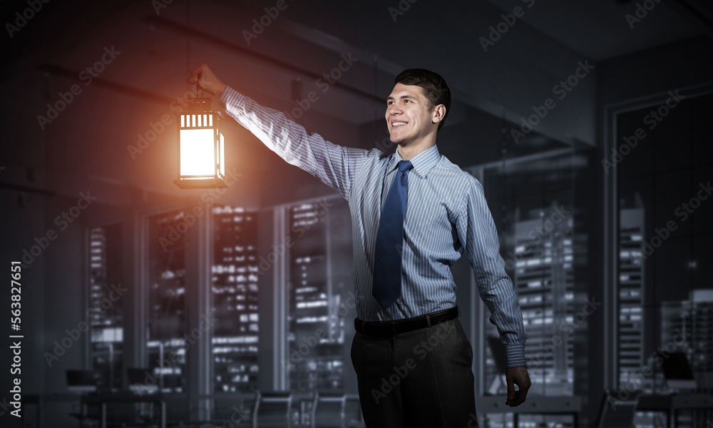 Fototapeta premium Happy businessman holding glowing lantern