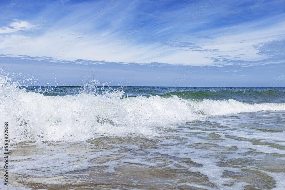 Fototapeta premium Beautiful tropical beach with blue sky with clouds as abstract nature background. Scenic landscape with sparkling waves ocean, aesthetic beauty nature. Summer day on Baltic sea, Curonian spit.