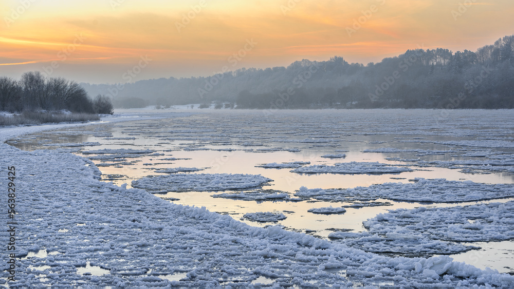 Amazing cold winter morning in Europe. Ice floes floating on a river. Amazing morning sunshine in extreme cold. Nemunas river in Lithuania.