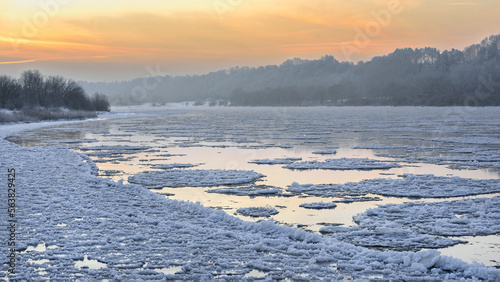 Obraz na płótnie Amazing cold winter morning in Europe. Ice floes floating on a river. Amazing morning sunshine in extreme cold. Nemunas river in Lithuania. w salonie
