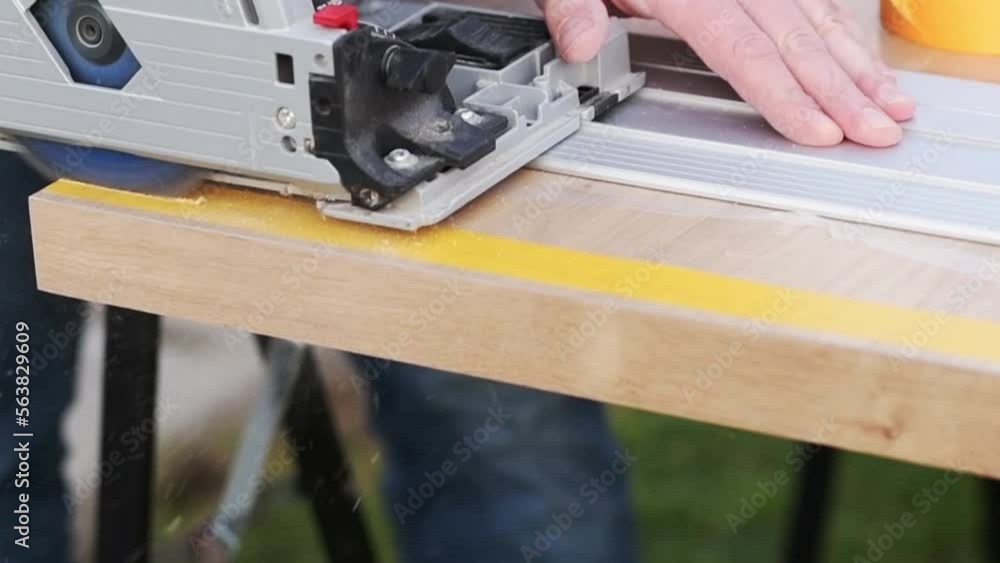 carpenter cutting wood with saw carpenter cutting wood with saw
