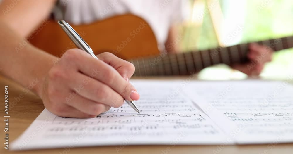 A woman writes notes with a pen, close-up, slowmotion A woman writes notes with a pen, close-up, slowmotion