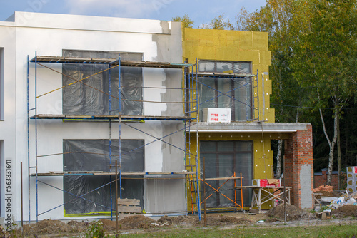view of construction worker in doing insulation of wall at construction site
