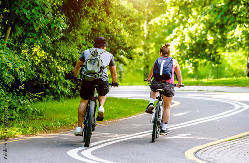 Wallpaper Mural Cyclists ride on the bike path in the city Park

 Torontodigital.ca