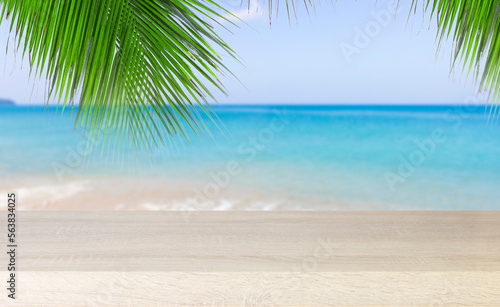 Fototapeta Naklejka Na Ścianę i Meble -  Empty wooden table with palm leaves and beach sea sky background , using for studio background and product display summer and presentation concept