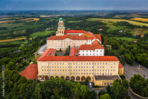 Pannonhalma, Hungary - Aerial view of the beautiful Millenary Benedictine Abbey of Pannonhalma (Pannonhalmi Apatsag) with blue sky and green foliage at summertime photo