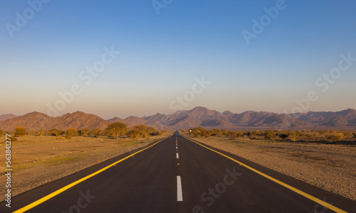 Desert road in remote rural area of Al Madinah in north western Saudi Arabia photo