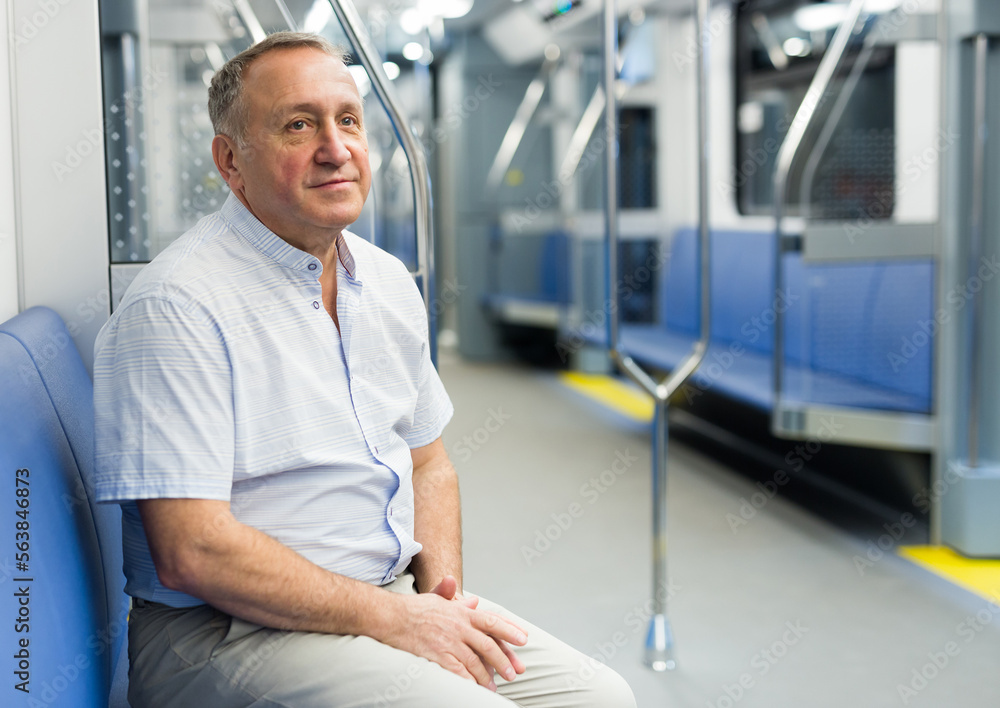 Fototapeta premium Middle aged man sitting in subway car