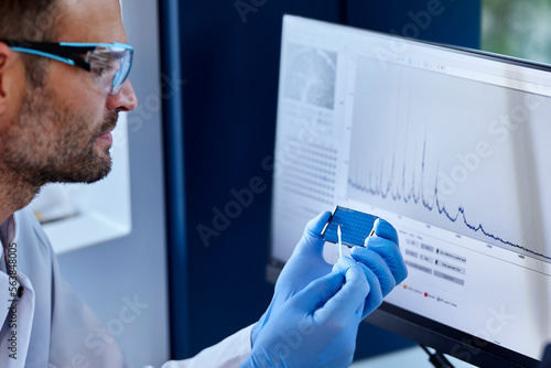 Scientist analyzing sample in a microbiological lab photo