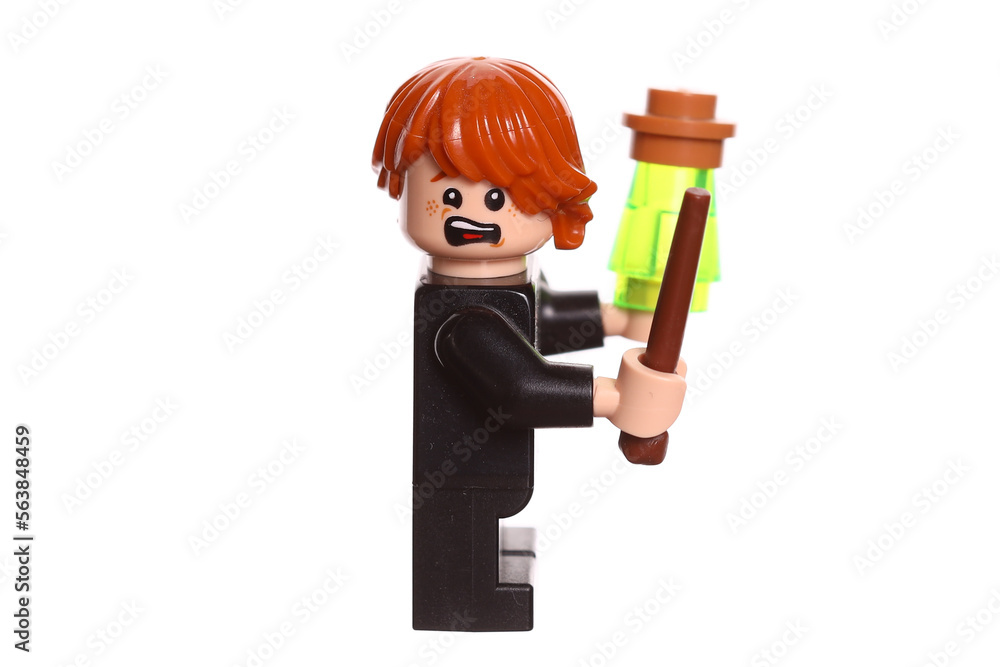 Fototapeta premium Russia Vyborg 01.22.2023 Lego figure Ron Weasley with a magic wand isolated on a white background. Side view