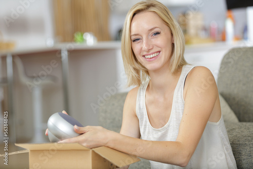 happy woman with box moving to new home