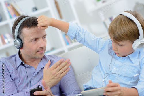 Child tapping father on head