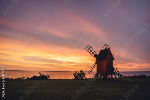 Sweden, Oland, Morbylanga, Coastal windmill at sunset photo