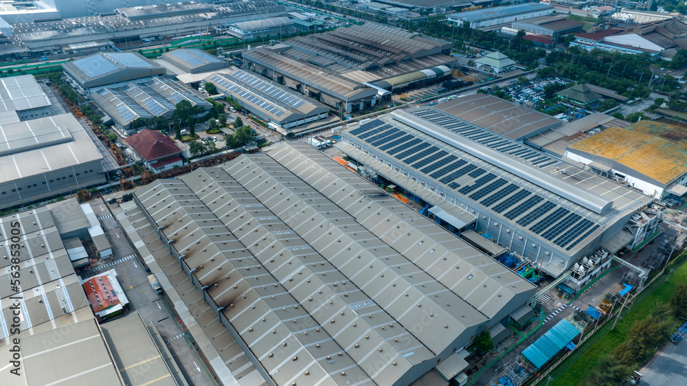 Top view Solar Cell on Warehouse Factory. Solar photo voltaic panels system power or Solar Cell on industrial building roof for producing green ecological electricity. Production of renewable energy.