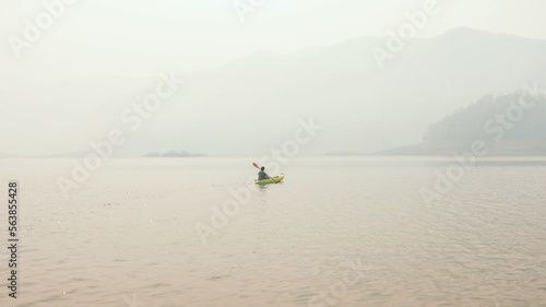 Kayak Water Sports at Lake. Kayakers enjoying the beautiful sunrise walks by sea kayak or canoe at tropical bay. relaxing with boat Beach summer holidays