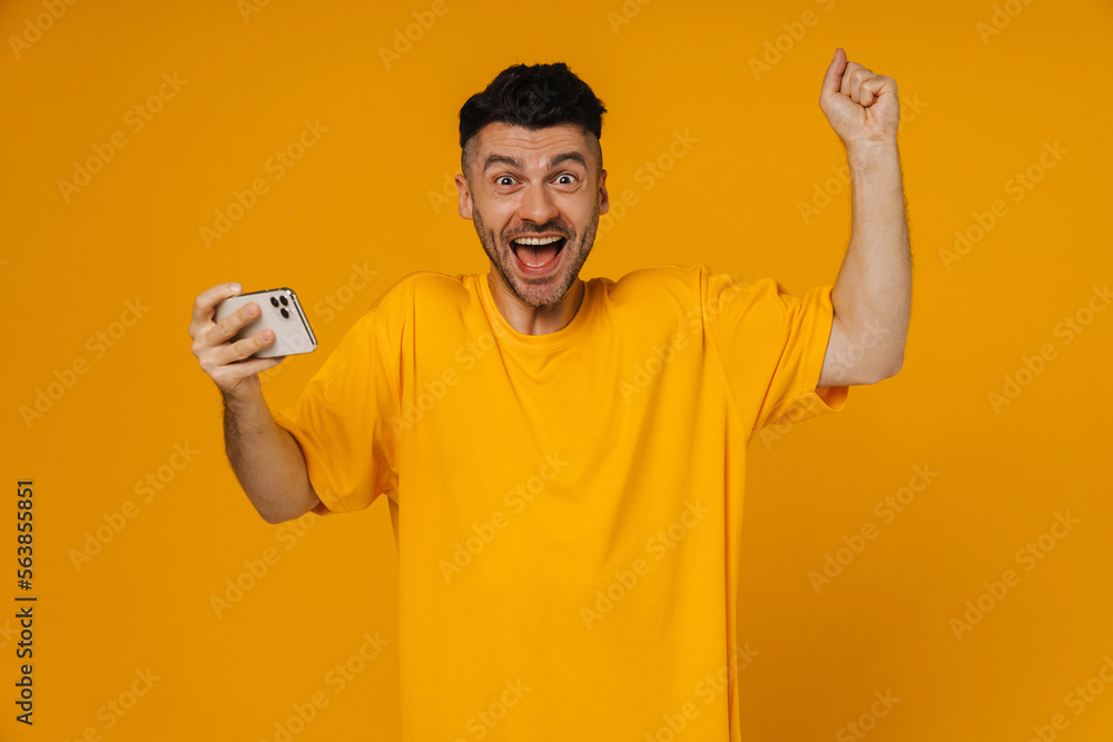 Young white unshaven man laughing while using cellphone Young white unshaven man laughing while using cellphone