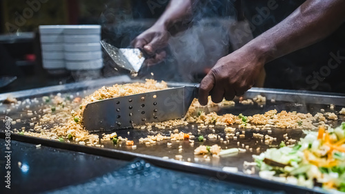 Slika na platnu Teppanyaki chef entertaining with spatulas