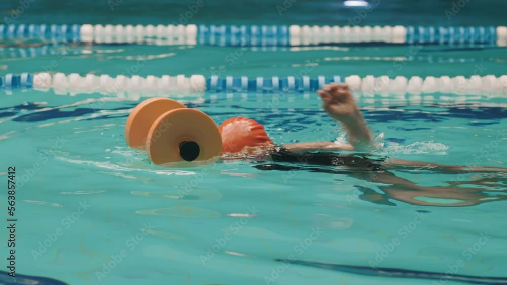 Beautiful Little Girl Learns To Swim Front Crawl With Aquatic Dumbbell