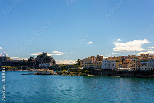 Kerkyra cityscape. Corfu island, Greece. Sea bay with calm turquoise water and colorful old houses.