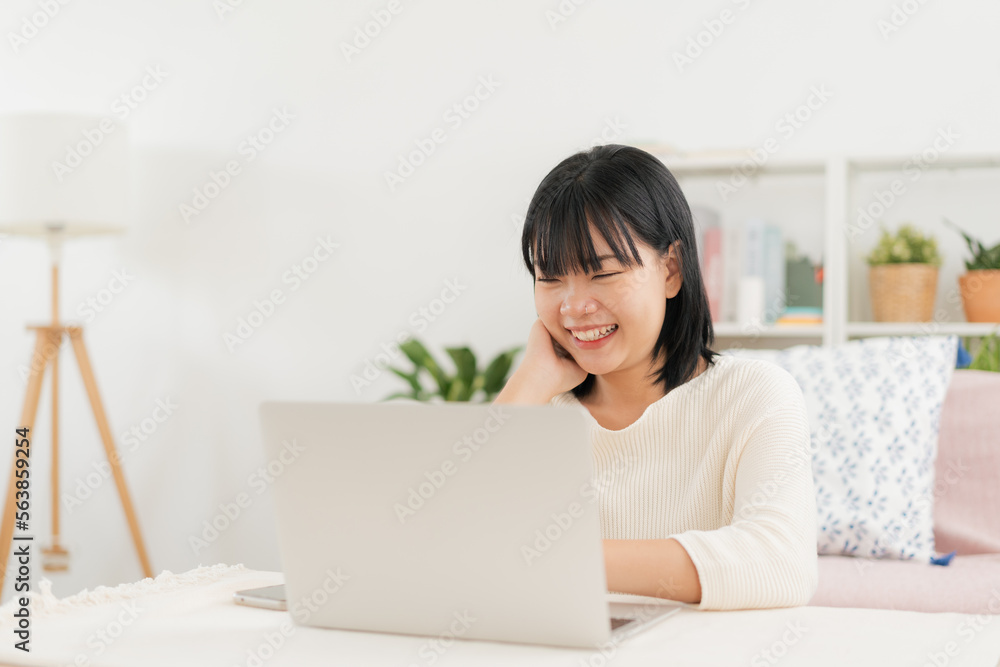 Asian woman happy smile using laptop at home Asian woman happy smile using laptop at home