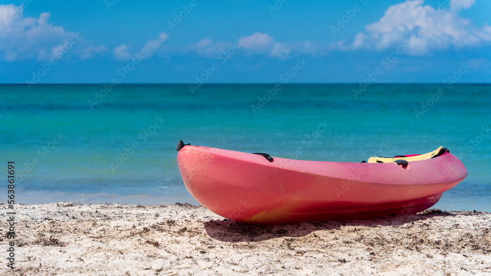 Kayak resting on a Caribbean beach Kayak resting on a Caribbean beach