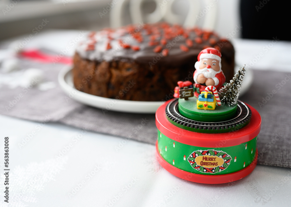 Aged cake, with dried fruit and brandy. Traditional aged English fruitcake for Christmas. Chocolate covered with guji berries. Christmas cake with alcohol. Very tasty, perfect for the festive table.