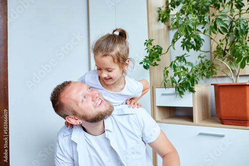 Father and daughter in white spending time at home