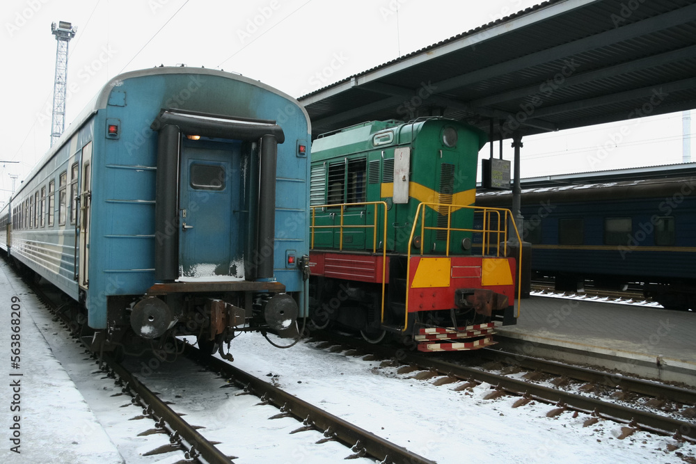 Naklejka premium Passenger train with diesel locomotive at the station, infrastructure of Ukraine