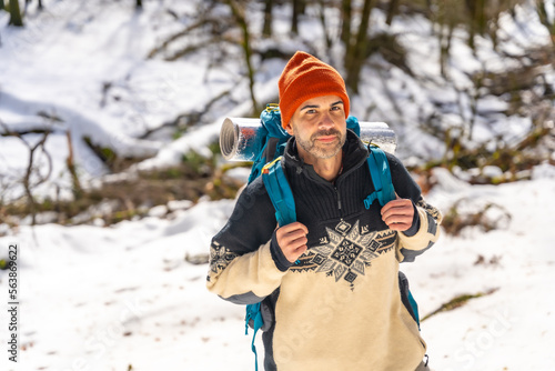 Hiker with backpack on a snow trek, winter adventures, natural activity, Artikutza, Gipuzkoa photo