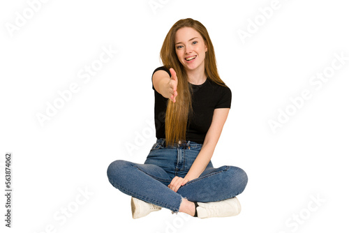 Young redhead woman sitting on the floor cut out isolated shocked covering mouth with hands.