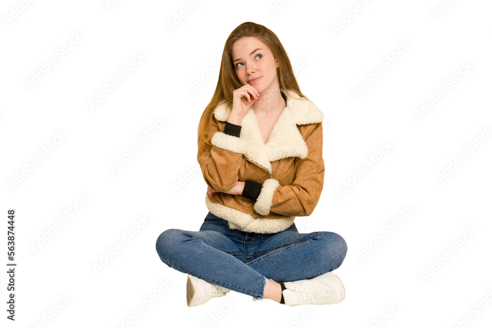 Young redhead woman sitting on the floor cut out isolated throwing a punch, anger, fighting due to an argument, boxing. Young redhead woman sitting on the floor cut out isolated throwing a punch, anger, fighting due to an argument, boxing.