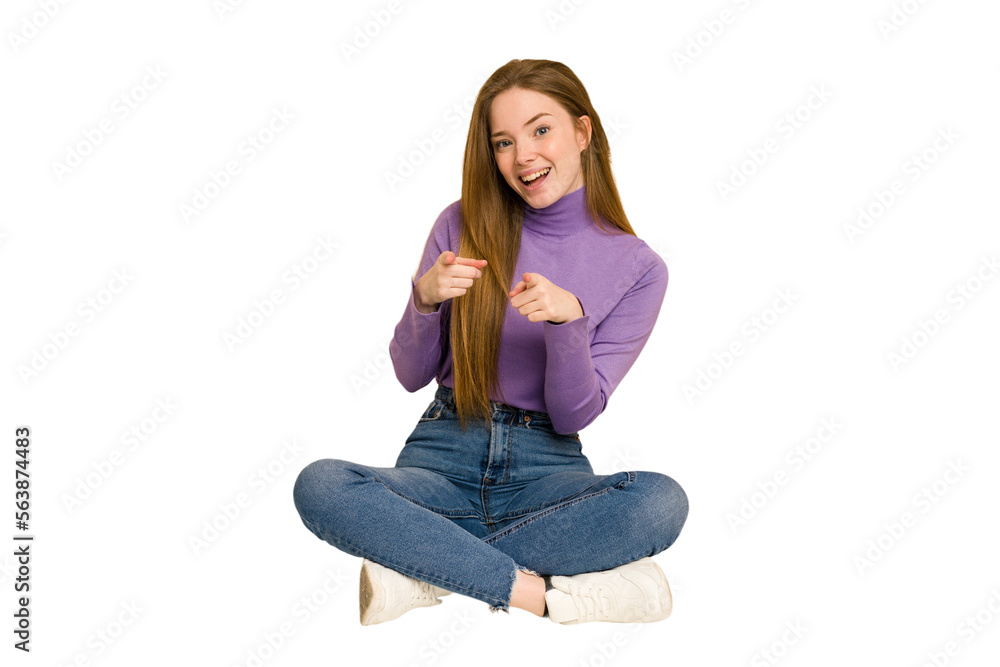 Young redhead woman sitting on the floor cut out isolated laughs and closes eyes, feels relaxed and happy. Young redhead woman sitting on the floor cut out isolated laughs and closes eyes, feels relaxed and happy.