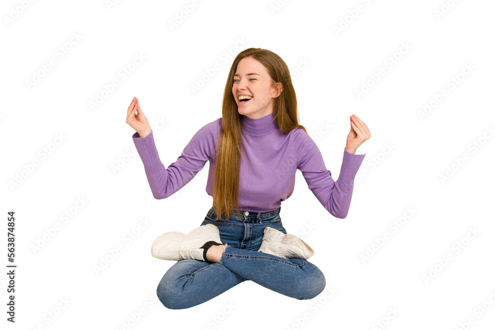 Young redhead woman sitting isolated cut out Young redhead woman sitting isolated cut out