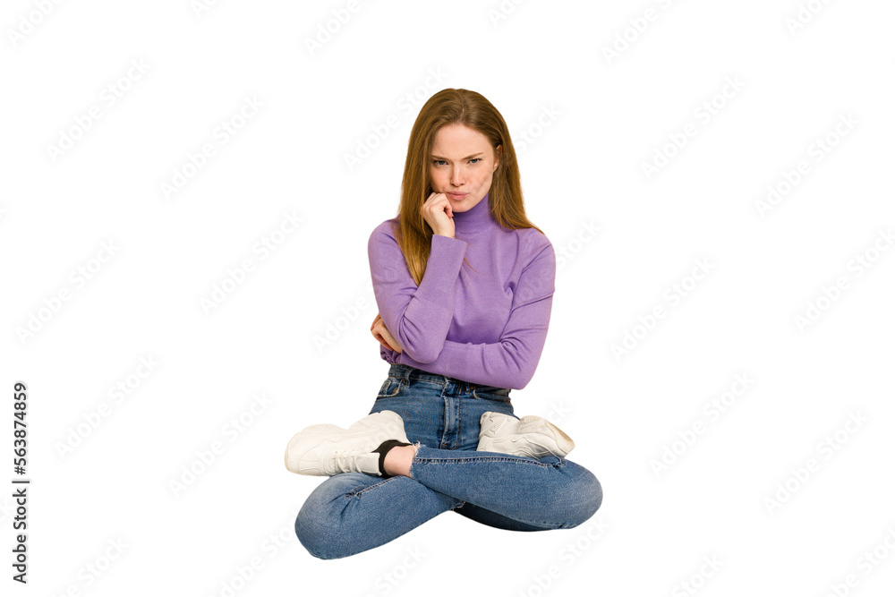 Young redhead woman sitting isolated cut out Young redhead woman sitting isolated cut out