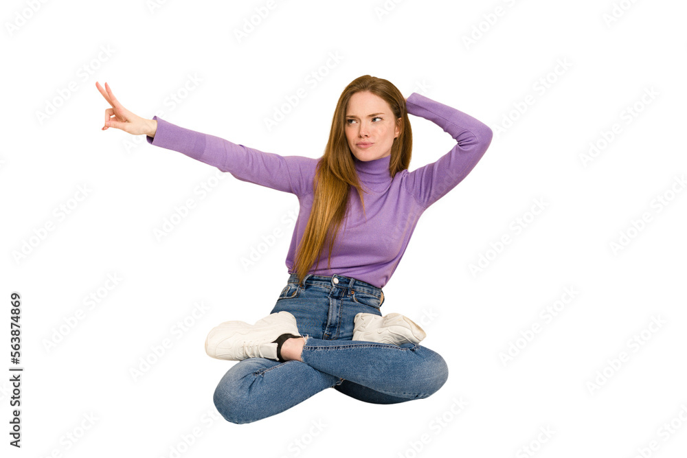 Young redhead woman sitting isolated cut out Young redhead woman sitting isolated cut out