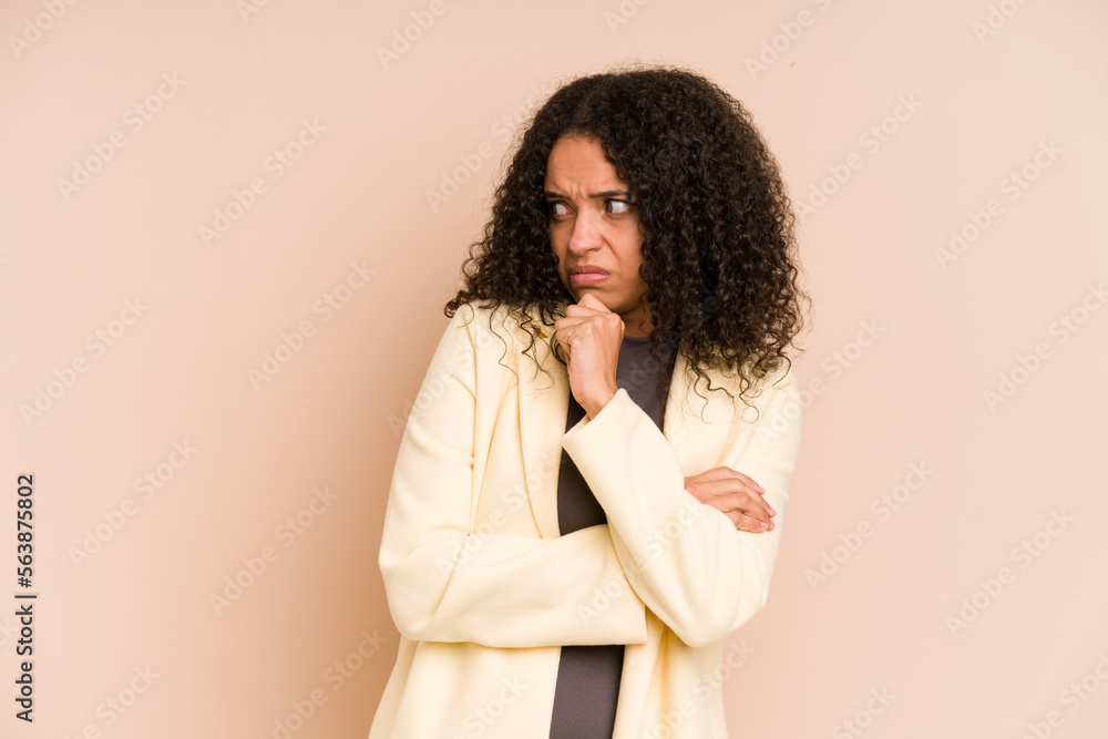 Young african american curly woman isolated confused, feels doubtful and unsure. Young african american curly woman isolated confused, feels doubtful and unsure.