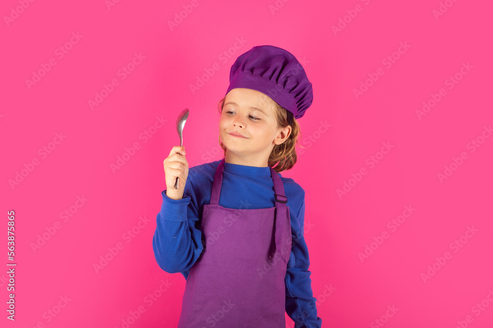 Child cook hold spoon. Cooking children. Chef kid boy making healthy food. Portrait of little child in chef hat isolated on studio background. Kid chef. Cooking process. Child cook hold spoon. Cooking children. Chef kid boy making healthy food. Portrait of little child in chef hat isolated on studio background. Kid chef. Cooking process.