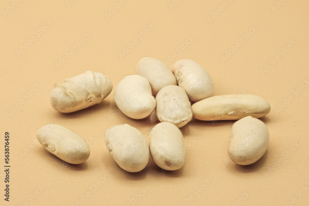 white beans isolated on orange background. top view white beans isolated on orange background. top view