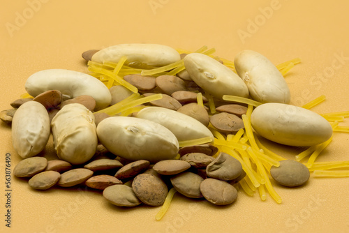 different legumes and noodles for healthy meals on orange background photo