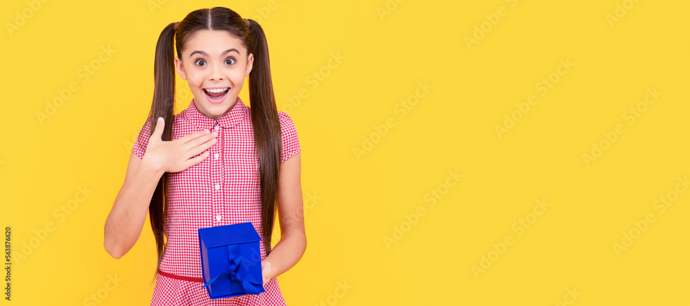 Teenager gift. surprised teen girl hold present box on yellow background, surprise. Teenager girl with birthday gift, horizontal poster. Banner header with copy space. Teenager gift. surprised teen girl hold present box on yellow background, surprise. Teenager girl with birthday gift, horizontal poster. Banner header with copy space.